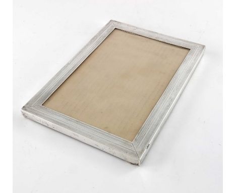 A George V silver photo frame, Mappin and Webb, London 1920, rectangular with engine turned pinstripe design, opening 17.5cm 
