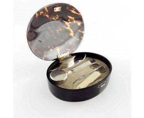 A George V silver and tortoiseshell manicure set in case, HA and Co., London 1925/26, the oval box with gilt hinged lid, cont