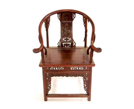 A Chinese hardwood armchair, carved and reticulated with foliate scroll brackets, panel seat, the back splat with relief carv