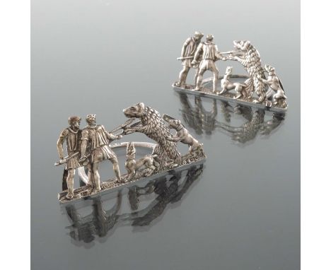 A pair of Victorian silver menu holders, Samuel Jacob, London 1899, cast in relief with figures and dogs hunting a bear, 7.5c