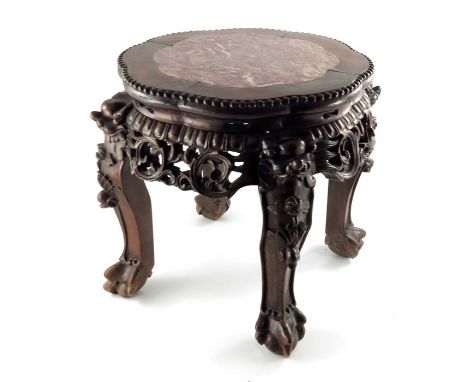 A Chinese carved hardwood and marble inset jardinière stand, relief moulded and reticulated with foliate scroll apron, on fou