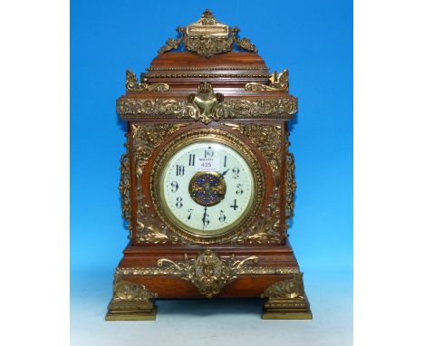 A Victorian oak bracket clock with extensive ornate brass mounts, white enamel dial, and striking movement, height 21"