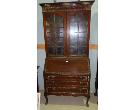 An early 20th century Chippendale style mahogany bureau bookcase with blind fret decoration, 2 glazed doors over fall front, 