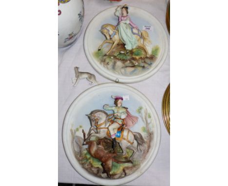 A pair of 19th century French circular bisque wall plaques depicting a 17th century man and woman on horseback, diameter 12" 