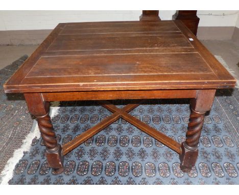 A large 1920's oak draw leaf table with block and barley twist supports united by cross stretchers, 42" square