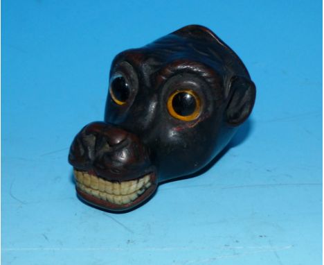 A 19th century carved wood novelty snuff box in the form of a monkey's head with glass eyes and bone teeth (ears chipped)