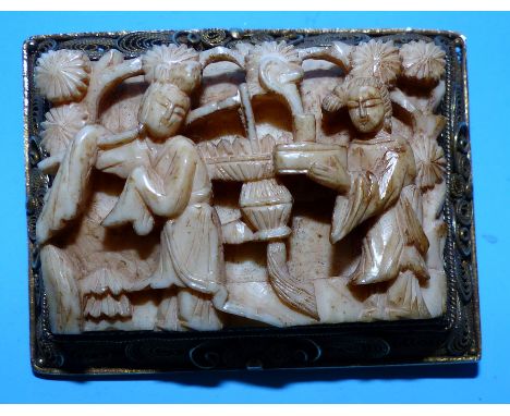 A 1930's oriental brooch with carved ivorine panel and filigree frame