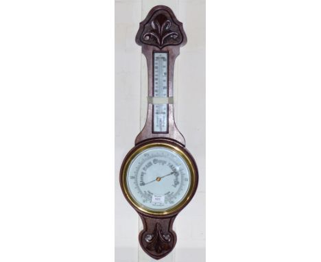 An Edwardian carved mahogany aneroid barometer with thermometer