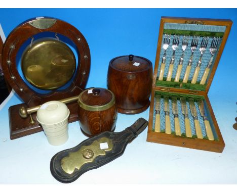 An oak cased set of 6 fish knives and forks; a dinner gong; an oak biscuit barrel and tea caddy