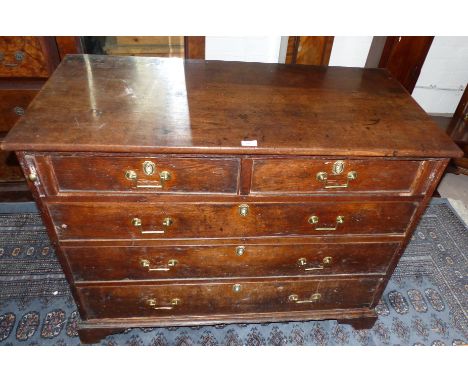 An 18th century oak chest of 3 long and 2 short drawers, with later brass drop handles and bracket feet