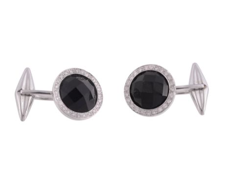 A pair of onyx and diamond cufflinks, the circular faceted onyx set within a...  A pair of onyx and diamond cufflinks,   the 