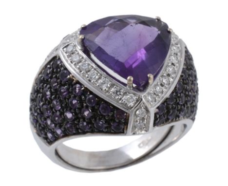 An amethyst, purple sapphire and diamond ring  An amethyst, purple sapphire and diamond ring,   the central triangular shaped