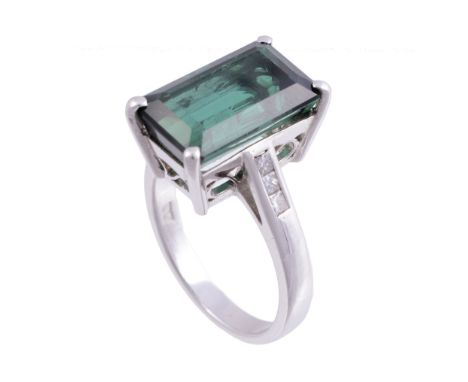 A green tourmaline and diamond ring, the rectangular step cut green...  A green tourmaline and diamond ring,   the rectangula