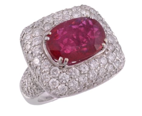 A French ruby and diamond cluster dress ring  A French ruby and diamond cluster dress ring,   the oval cut ruby estimated to 
