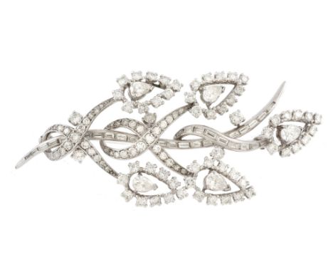 A diamond spray brooch, the foliate spray composed of twisting stems set...  A diamond spray brooch,   the foliate spray comp