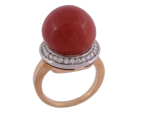 A coral and diamond ring, the 14.2mm coral within a surround of brilliant...  A coral and diamond ring,   the 14.2mm coral (c