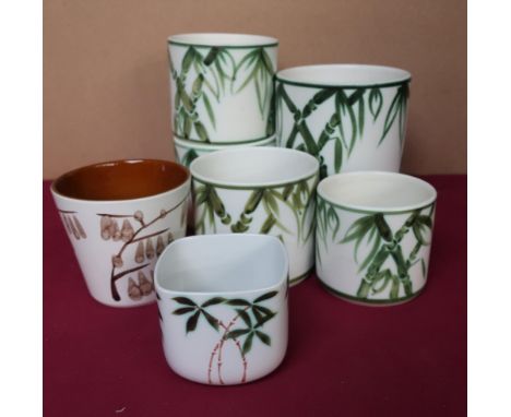 Poole Pottery jardinières with green bamboo hand painted design, another with brown painted design, and another smaller with 