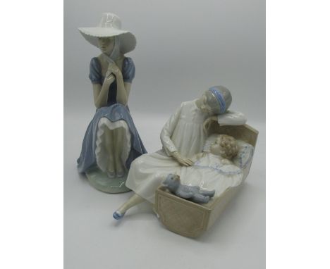 Nao Lladro figurine of a seated lady and another of a mother and child in a cot 