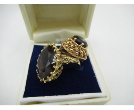 9ct gold hallmarked dress ring set with a large oval smokey quartz and 9ct gold hallmarked with a raised set garnet (2) 