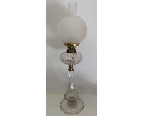 Edwardian clear glass oil lamp, with faceted tapering column,circular base and resevoir, opaque glass globe shade, H75cm 