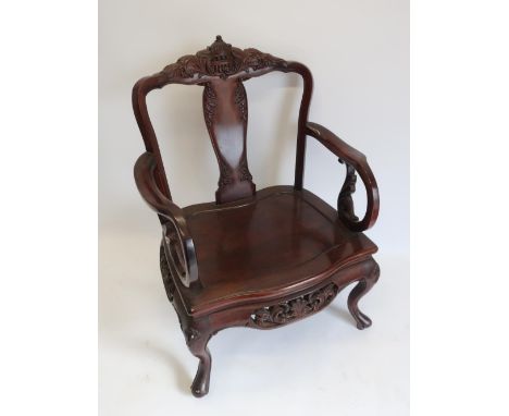 Early 20th C Chinese padouk wood open armchair, with floral carved top rail and vase shaped splat, solid seat with scroll arm