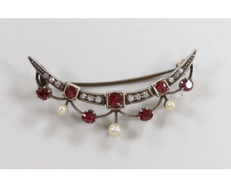 A late Victorian yellow metal, diamond, ruby and seed pearl set crescent brooch, 45mm, gross weight 4.9 grams.