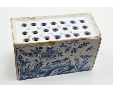 A mid 18th century English delftware flower brick, probably Lambeth, painted in underglaze blue with a stylised pheasant and 
