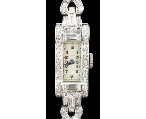 A lady's 1930's/1940's platinum, baguette and round cut diamond set rectangular dial manual wind cocktail watch, on a white g