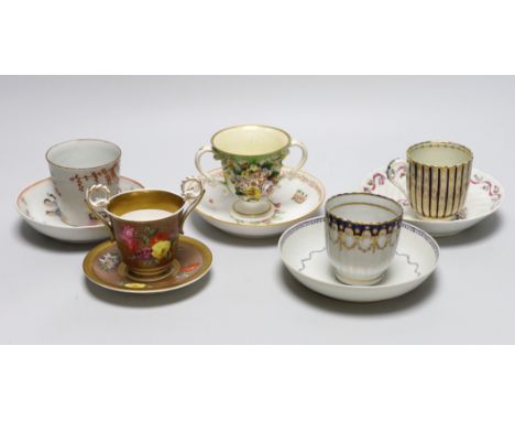 A group of early 19th century English porcelain cups and various saucers to include a Spode two handled chocolate cup and sau