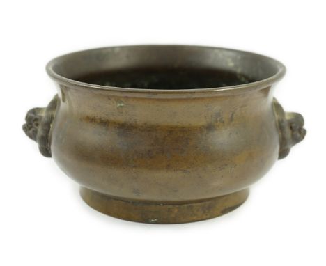A Chinese bronze censer, gui, 18th century, with olive-brown patina, cast with a pair of lion-mask handles, the baluster-shap