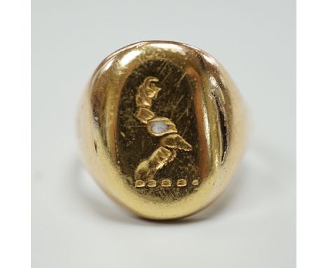 A yellow metal signet ring, carved with a crest, size K, 5.2 grams.