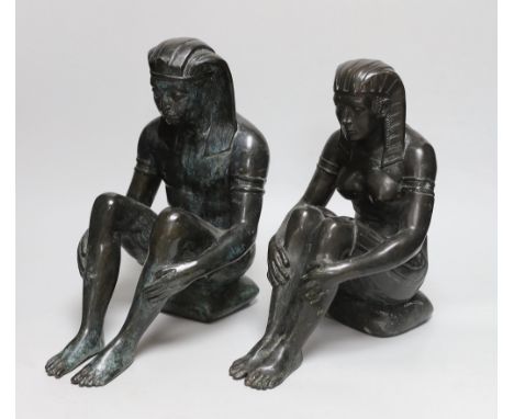 A pair of cast bronze seated Egyptian figures wearing headdresses, the largest 30cm high