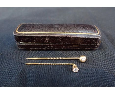 AN 18ct GOLD STICK PINand another with indistinct mark, in an old leather case