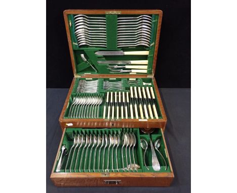 A WALKER & HALL OAK-CASED SILVER-PLATED CANTEENwith engraved shield to the lid, 1934 (case handles a/f)