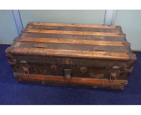 AN OLD METAL-BOUND TRUNK CONTAINING VARIOUS ITEMS;a pair of Hunter Wellington boots, in silver, size 4, another pair of welli