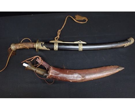 A CHINESE SHORT SWORD (DAO) AND SCABBARDwith 55.5cm blade, and woven grip, with engraved brass fittings and pierced and engra