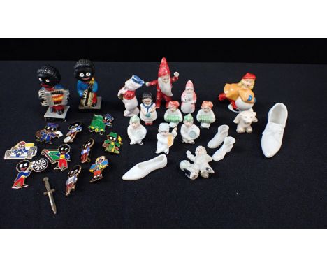 A COLLECTION OF VINTAGE BISQUE CAKE DECORATIONSFather Christmas, snow baby and others, and a few Robertson's Golly badges and