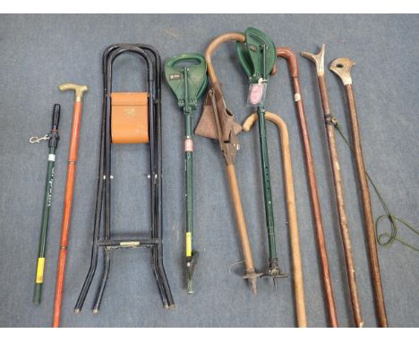 A COLLECTION OF SHOOTING STICKSand other sticks, including a modern Bisley 'Gripseat', a modern brass-handled stick with inte
