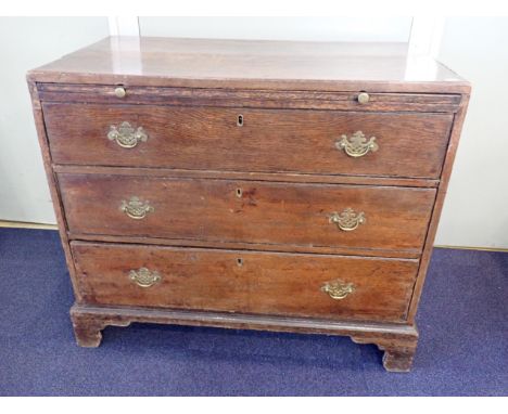 AN 18th CENTURY OAK 'BACHELOR' CHEST OF DRAWERSwith brushing slide, and (replacement) brass handles, on bracket feet 92cm wid