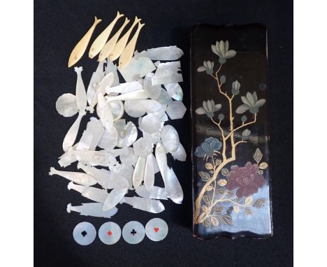 A QUANTITY OF CHINESE MOTHER-OF-PEARL AND BONE GAMING COUNTERSmostly of fish shape, contained in black lacquered glove box