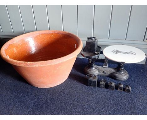 A LARGE19th CENTURY EARTHENWARE MIXING BOWLwith glazed interior 47cm dia, and a set of cast iron kitchen scales with transfer