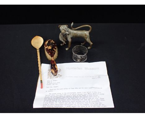 A BENIN STYLE DECORATED BRASS ANIMALwith a letter from the Hunterian Museum identifying it as modern, and a tribal coral moun