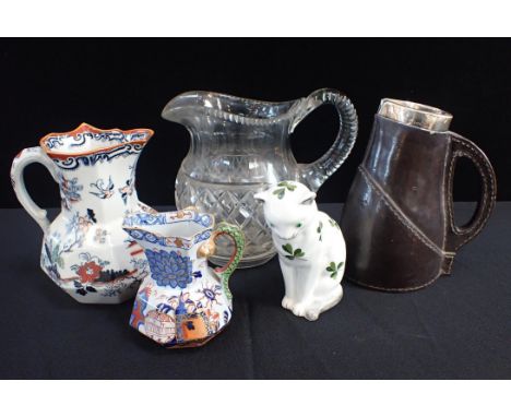 A WEMYSS STYLE PLICHTA POTTERY CATwith a silver mounted Doulton leather ware jug, a Davenport Imari style jug and a similar M