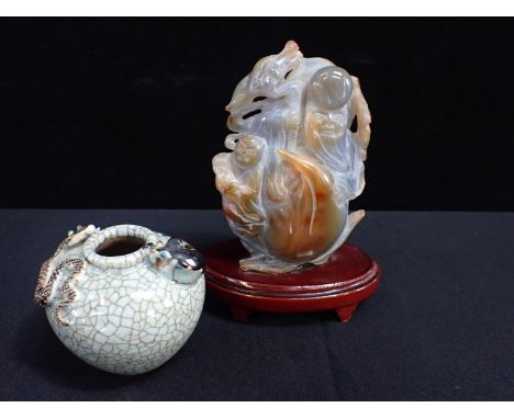 A CARVED JADE GROUP, SHOULOU & BOY20th century, on wooden base, 20 cms high, with a crackle glazed vase with applied creature