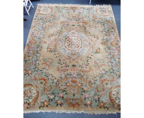 A LARGE CHINESE CARPET IN THE AUBUSSON STYLEin cream and green with scrolling foliage 275 x 370cm plus fringes