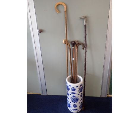 A CARVED OTTER HEAD WALKING STICKwith glass eyes (a/f), a cast metal greyhound head stick, a carved bulldog head umbrella han