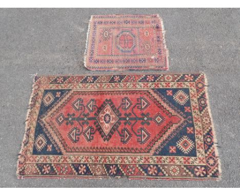 A SMALL ANTIQUE PERSIAN RUG60 x 66cm, and another rug 76 x 127cm (worn, frayed)