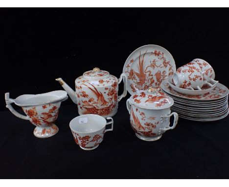 A 19th CENTURY CHINESE EXPORT PART TEA SERVICEpainted in orange with exotic birds amongst foliage, and gilt, the teapot and s