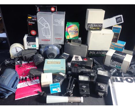 A QUANTITY OF PHOTOGRAPHIC EQUIPMENTPolaroid 330, flashgun, Cobra bracket, Canon wide-angle lens, Weston exp. meter, and othe