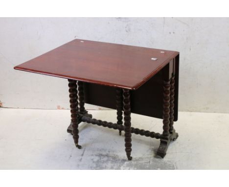 19th century Mahogany Sutherland Table raised on bobbin supports with castors, 84cm long x 72cm high 